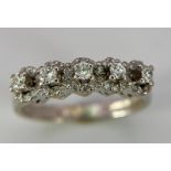 A Vintage 18K White Gold Five Stone Diamond Ring. Five brilliant round cut diamonds each with its