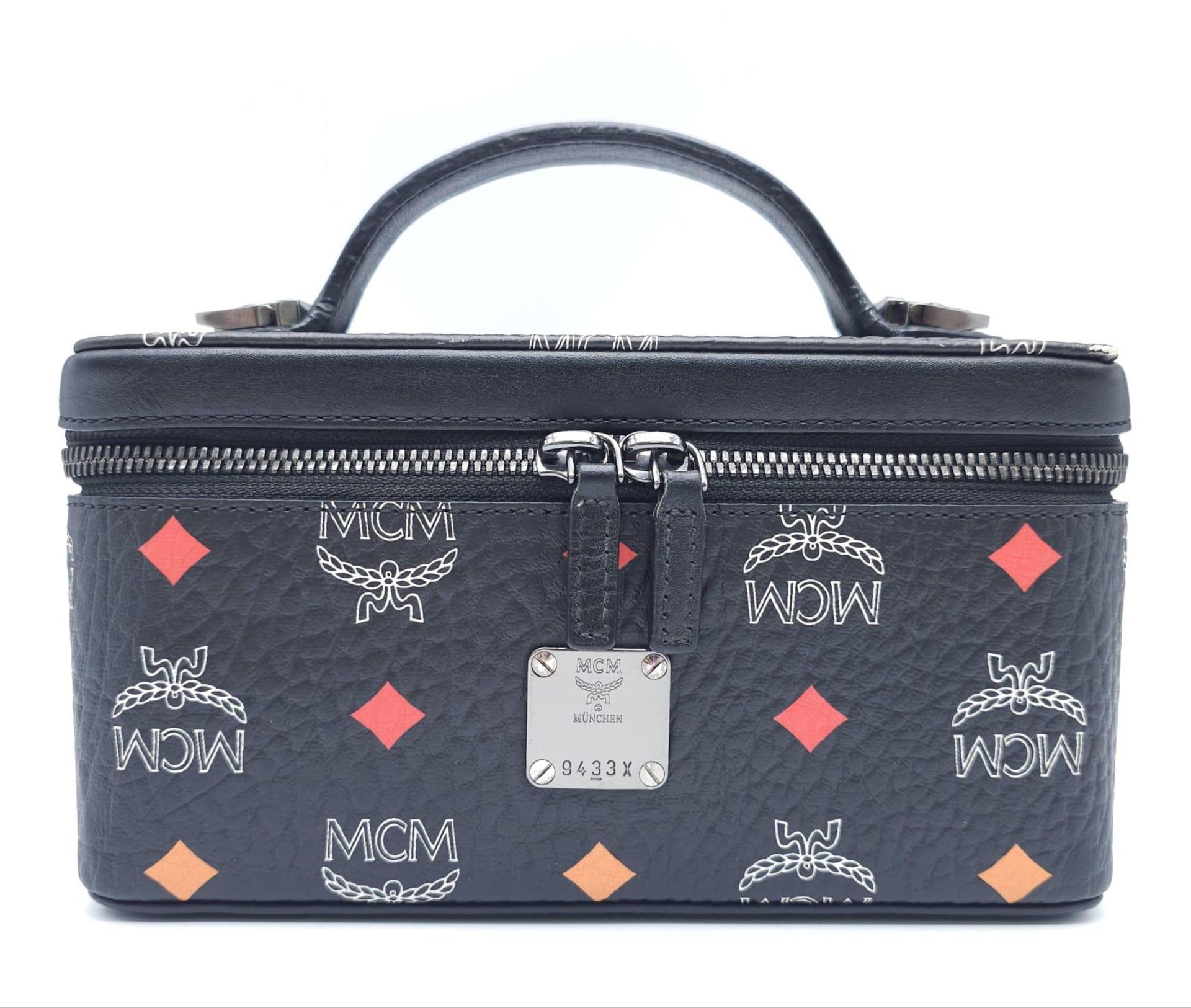 An MCM Rockstar Vanity Case Bag. Leather exterior with leather handle, detachable and adjustable