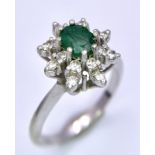 AN 18K (TESTED) WHITE GOLD RING WITH CENTRAL EMERALD SURROUNDED BY DIAMONDS IN A FLORAL FORM . 4.