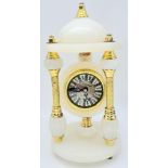 A Vintage White Onyx Mantle Clock. Featuring three pillars, gold tone metal and elaborate
