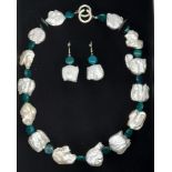 A highly unusual necklace and earrings set with large natural white baroque pearls alternating