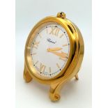 A Chopard Happy Sport Gold Plated Table Clock. Quartz movement. 7.5cm diameter. White dial with
