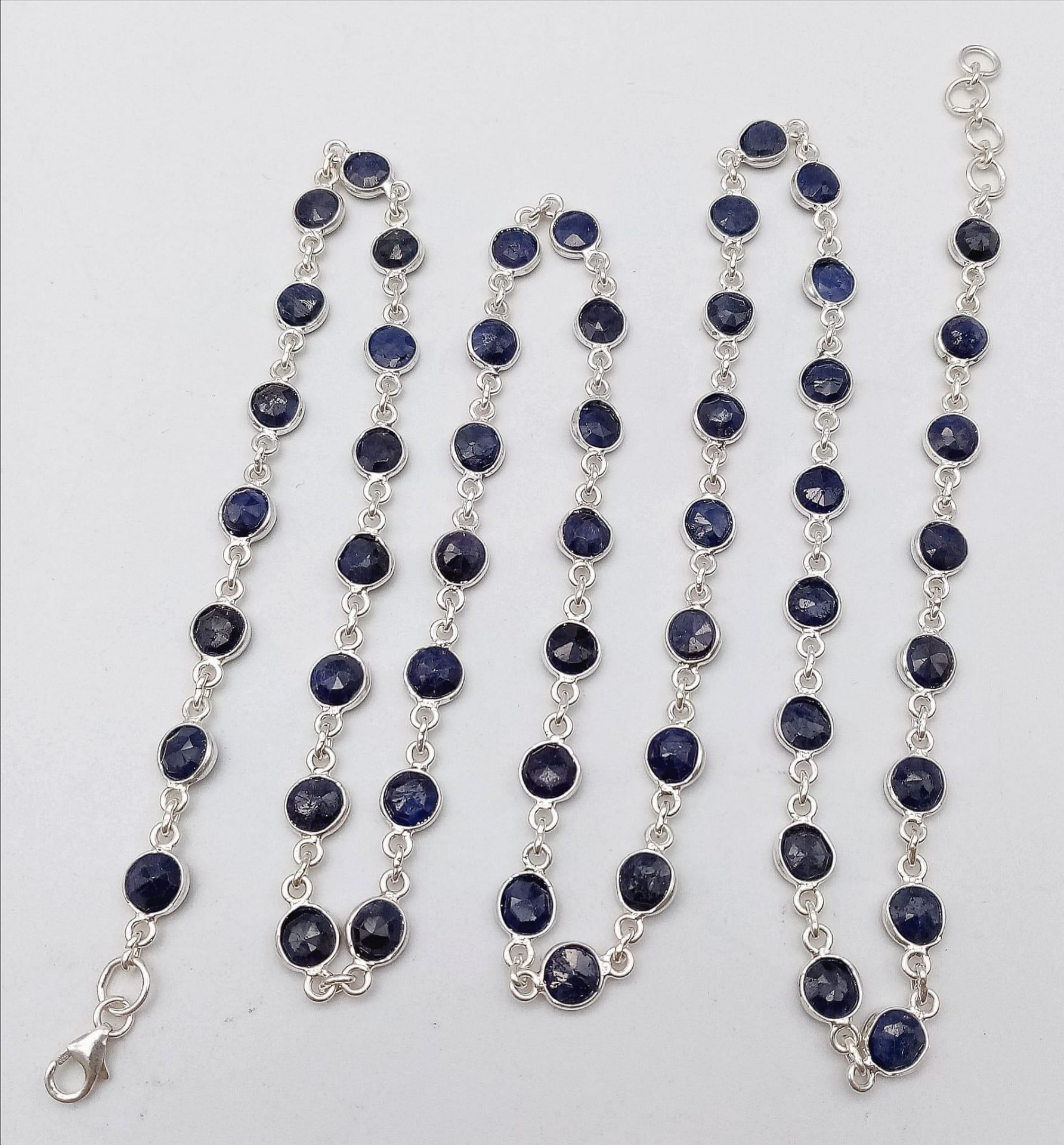 A Round Cut Blue Sapphire Gemstone Chain Necklace set in 925 Silver. 74cm length. 23.6g weight. Ref: