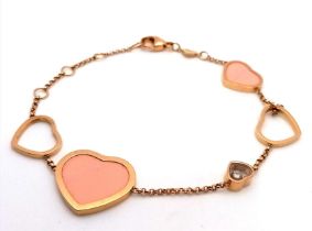 An 18 K yellow gold CHOPARD bracelet with pink stone hearts and a Happy Floating Diamond. Total