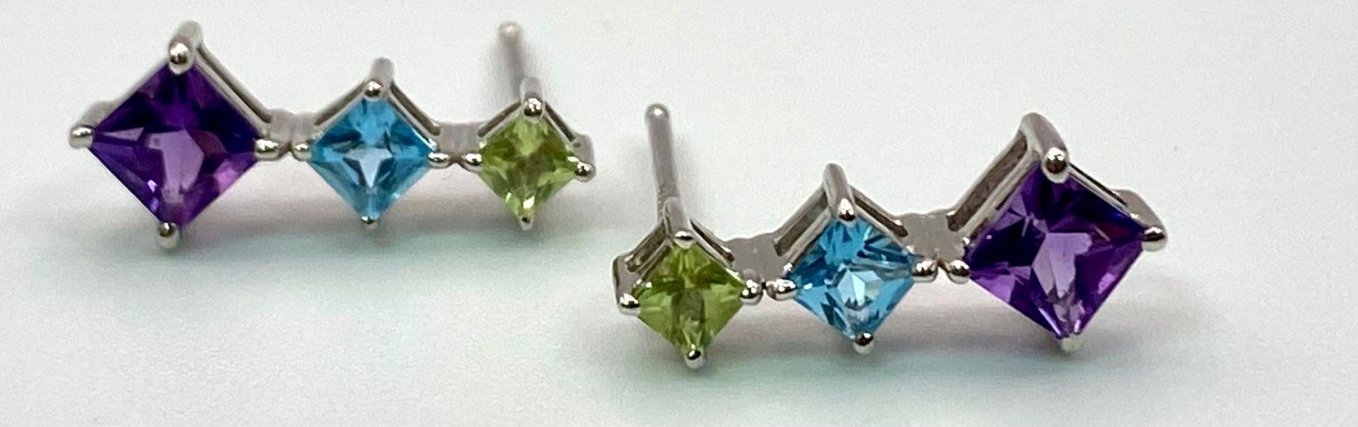 A Pair of 18K White Gold Gemstone Drop Earrings. Peridot, topaz and amethyst. 15mm drop. No backs.