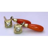 A PAIR OF 0.25ct DIAMOND EARRINGS WITH A CORAL DROP SET IN 18K GOLD . 2.4gms