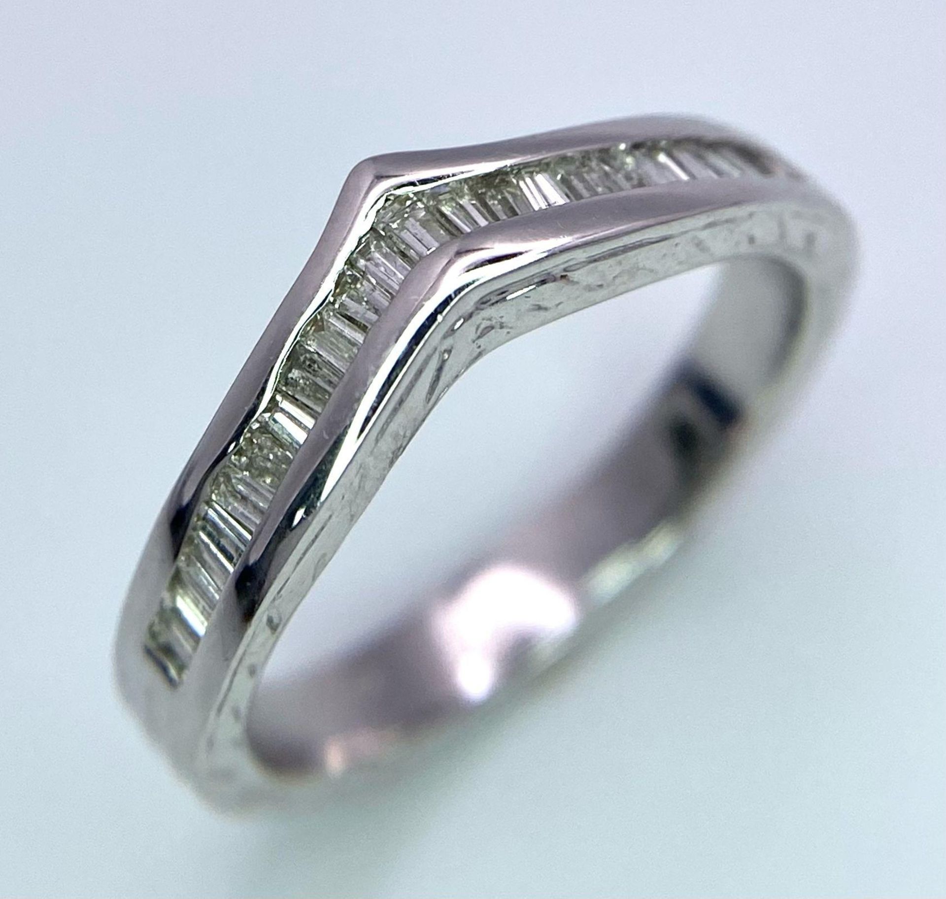 An 18K White Gold Wishbone, Baguette Cut Diamonds, Half Eternity Ring. Size J, 0.30ctw, 3.5g total