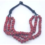 A Three Row Blood Red African Coral Necklace. Rondelle coral beads with gilded spacers. 44-48cm.