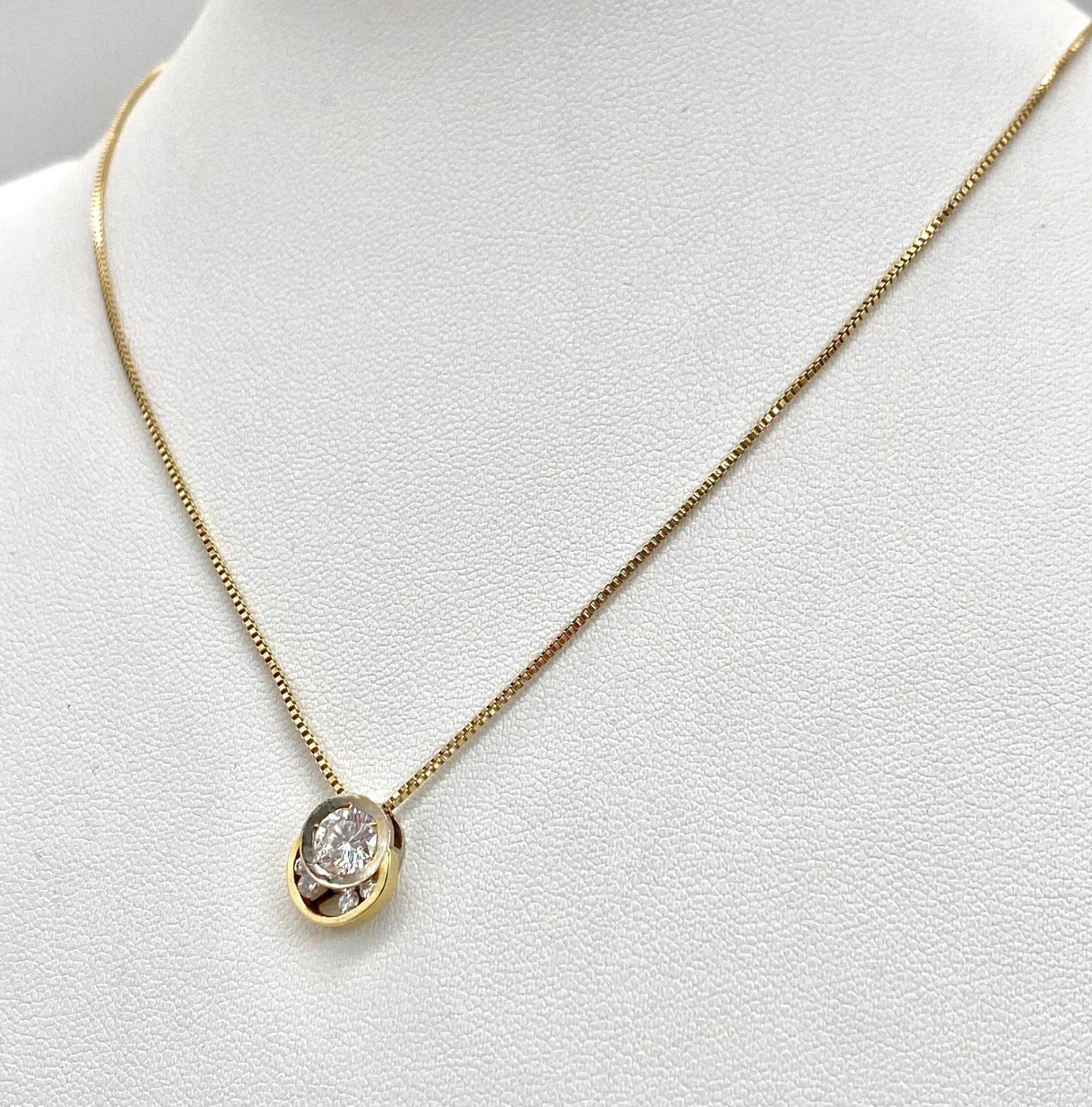 A DESIGNER WHITE AND YELLOW GOLD DIAMOND PENDANT ON A 40cme 14K GOLD CHAIN .4.25gms 009048