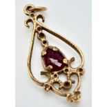 An Art Deco Style 9K Gold and Ruby Pendant. 25mm. 1g total weight.