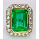 AN EXQUISITE 7.6ct COLOMBIAN OCTAGONAL CUT EMERALD SURROUNDED BY A HALO OF FINE QUALITY DIAMONDS