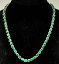 An Emerald Gemstone Tennis Necklace set in 925 Silver. 47cm length. 40g total weight.