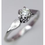 An 18 Carat White Gold Diamond Set Solitaire Ring Size N. Approx .10-.12 Carats. Ring Gross Weight