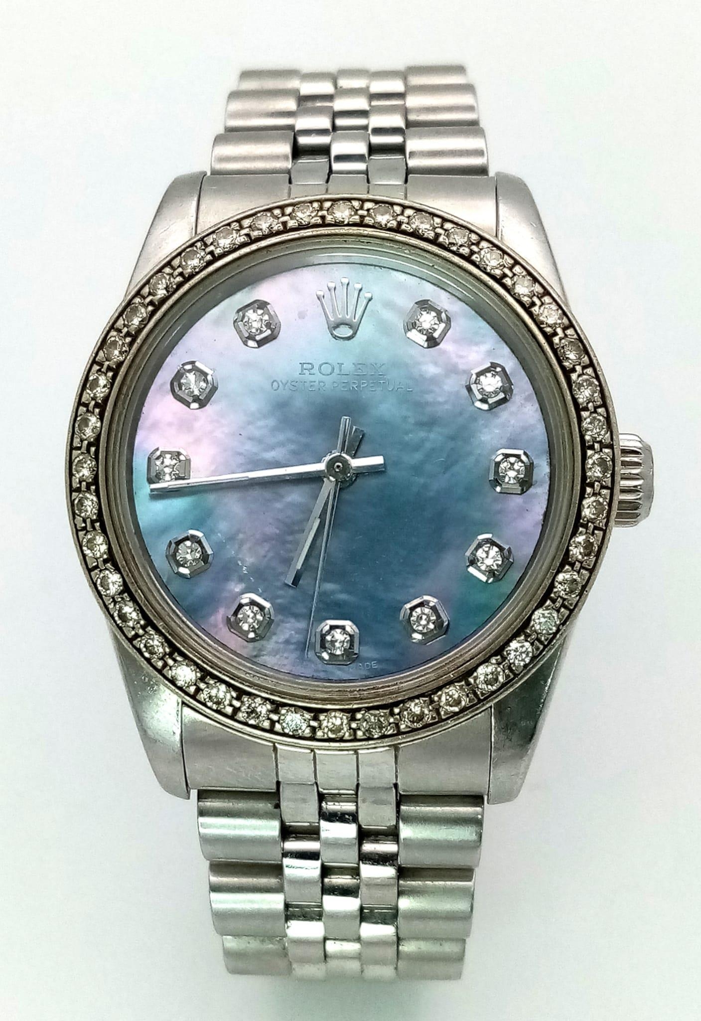 A LADIES ROLEX DRESS WATCH WITH DIAMOND NUMERALS AND BEZEL , MOTHER OF PEARL DIAL AND AUTOMATIC