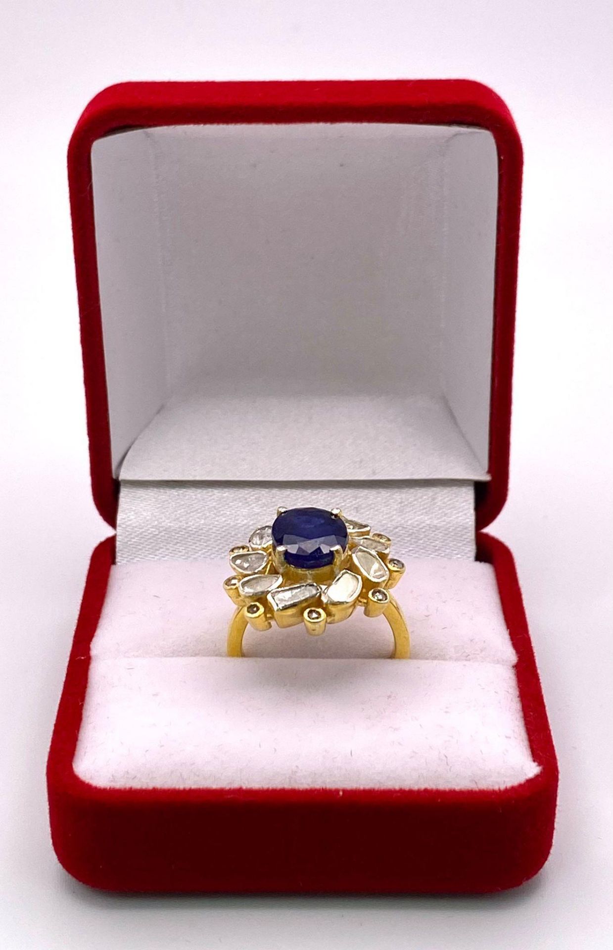 An eye-catching silver and gold ring with an oval cut blue sapphire surrounded by a group of large - Image 4 of 4