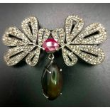 An Extraordinary, Diamond, Black Opal and Ruby Brooch. An 8ct Black fire Opal hangs from 3.7ctw of