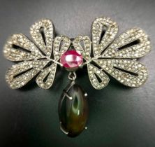 An Extraordinary, Diamond, Black Opal and Ruby Brooch. An 8ct Black fire Opal hangs from 3.7ctw of