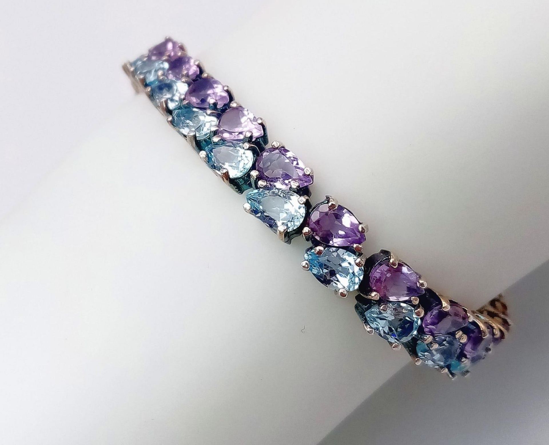 A Sterling Silver, double row bracelet set with Amethyst and Topaz. Measures 20cm in length. Weight: - Image 9 of 10