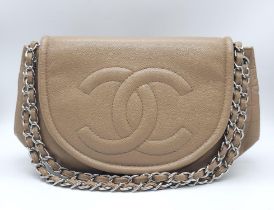 A Chanel Taupe Half Moon Flap Bag. Caviar leather exterior with diamond quilting through the base