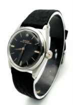 A ROLEX VINTAGE UNISEX OYSTER- SPEEDKING WATCH IN STAINLESS STEEL WITH BLACK LEATHER STRAP . 30mm