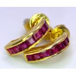 A 14 K yellow gold pair of ruby set earrings. weight: 2.3 g