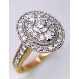 An 18 k yellow gold ring with a cluster of diamonds and more diamonds on the shoulders. Diamond