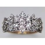 An 18K Yellow Gold Diamond Cluster Ring. 23 round cut diamonds create the perfect crown effect. Size