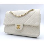 Chanel Cream Maxi. Double handled, quilted in diamond stitching and quality leather throughout. Gold