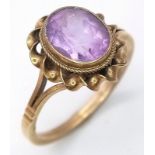 A Vintage 9K Yellow Gold Amethyst Ring. Central oval amethyst in a twist setting. Size P. 2.75g