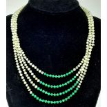 A very elegant, ART NOUVEAU, four row necklace with natural faceted peridot and emerald rondelles,