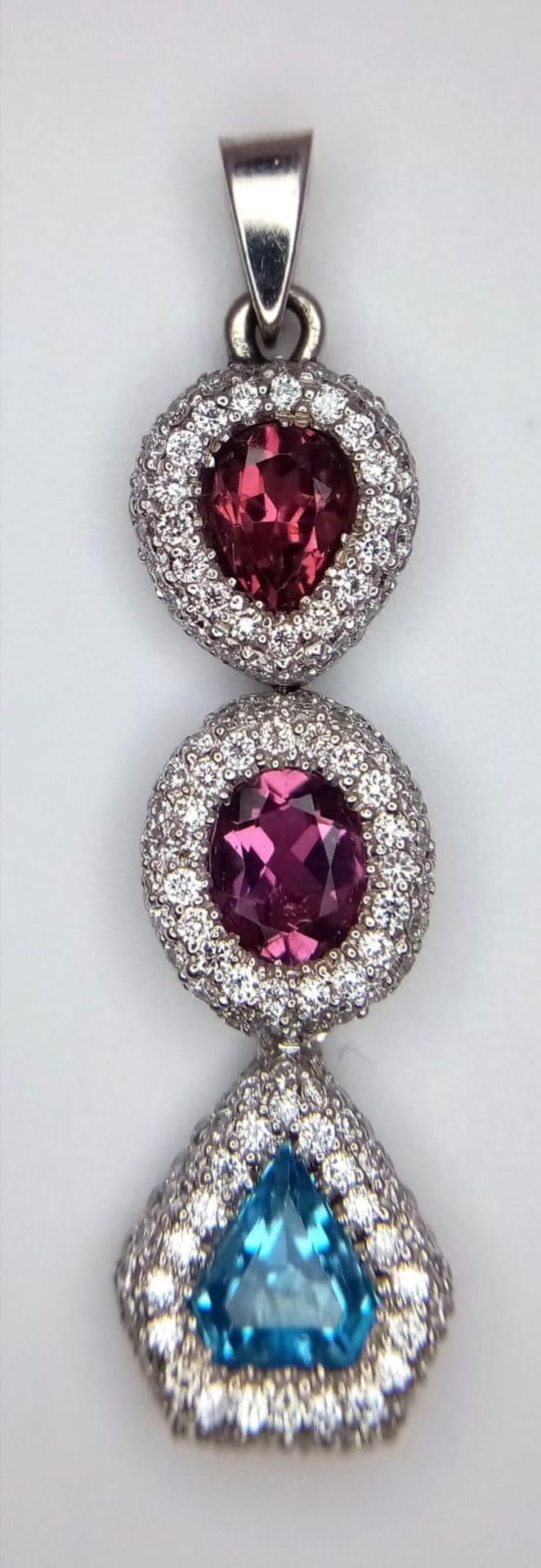 An 18K White Gold (tested) Ruby, Diamond and Topaz Drop Pendant. Three gemstones with diamond - Image 2 of 6