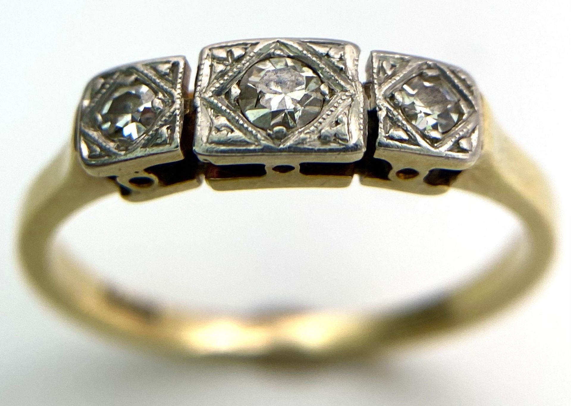 A 18kt Yellow Gold Ring with Trio of Diamonds. Each of the three Diamonds are mounted and framed