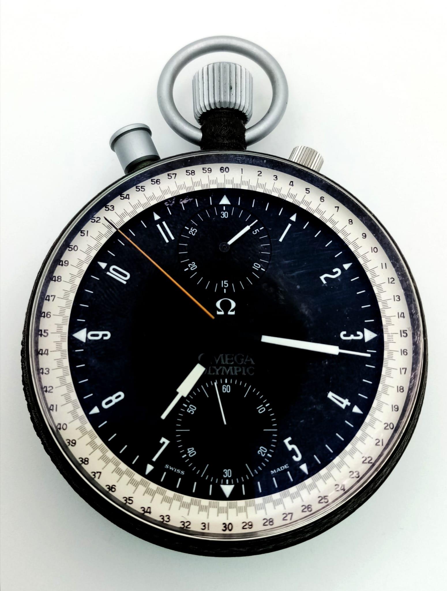 A Rare Vintage Omega Olympic Stopwatch. Top-winder. Black dial with three sub dials - minutes,