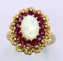 A Beautiful Vintage 14k Yellow Gold, Opal and Ruby Ring. Central oval colour-play opal with a halo