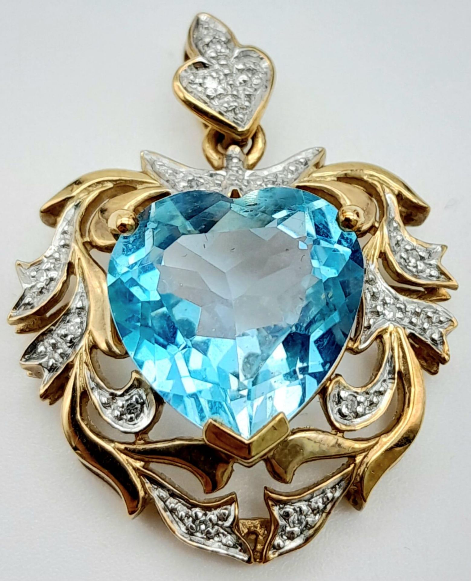 A Sumptuous Antique Style 9K Yellow Gold, Aquamarine and Diamond Pendant. Heart-shape cut aquamarine