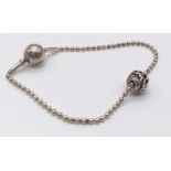 A sterling silver PANDORA friendship bracelet with two beads/charms. Weight: 6.8 g.