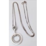 An 18K White Gold Diamond Set Circular Articulated Pendant on a Box Chain. 7.9g total weight. 16"