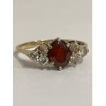 9 carat GOLD Garnet and Zirconia Ring. Full UK hallmark. Complete with ring box. 1.77 grams. Size N.