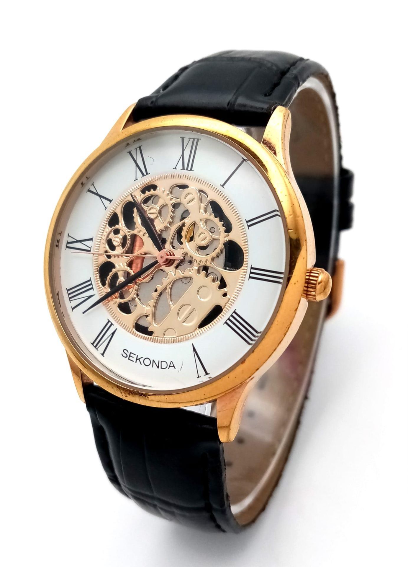 A Sekonda Automatic Skeleton Gents Watch. Black leather strap. Gilded case - 37mm. Skeleton dial. In