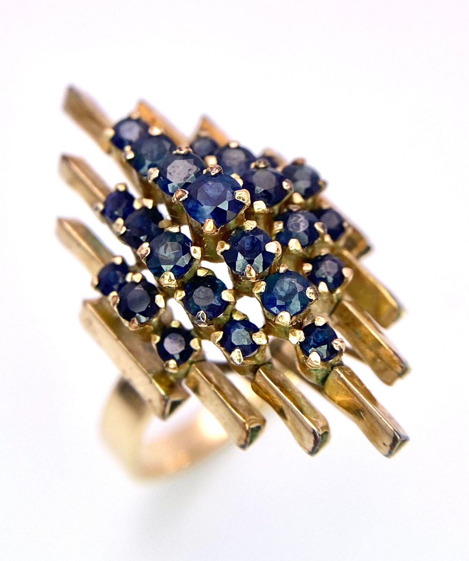 A vintage, 14 K yellow gold ring with a crown of sapphires arranged on a group of proud standing