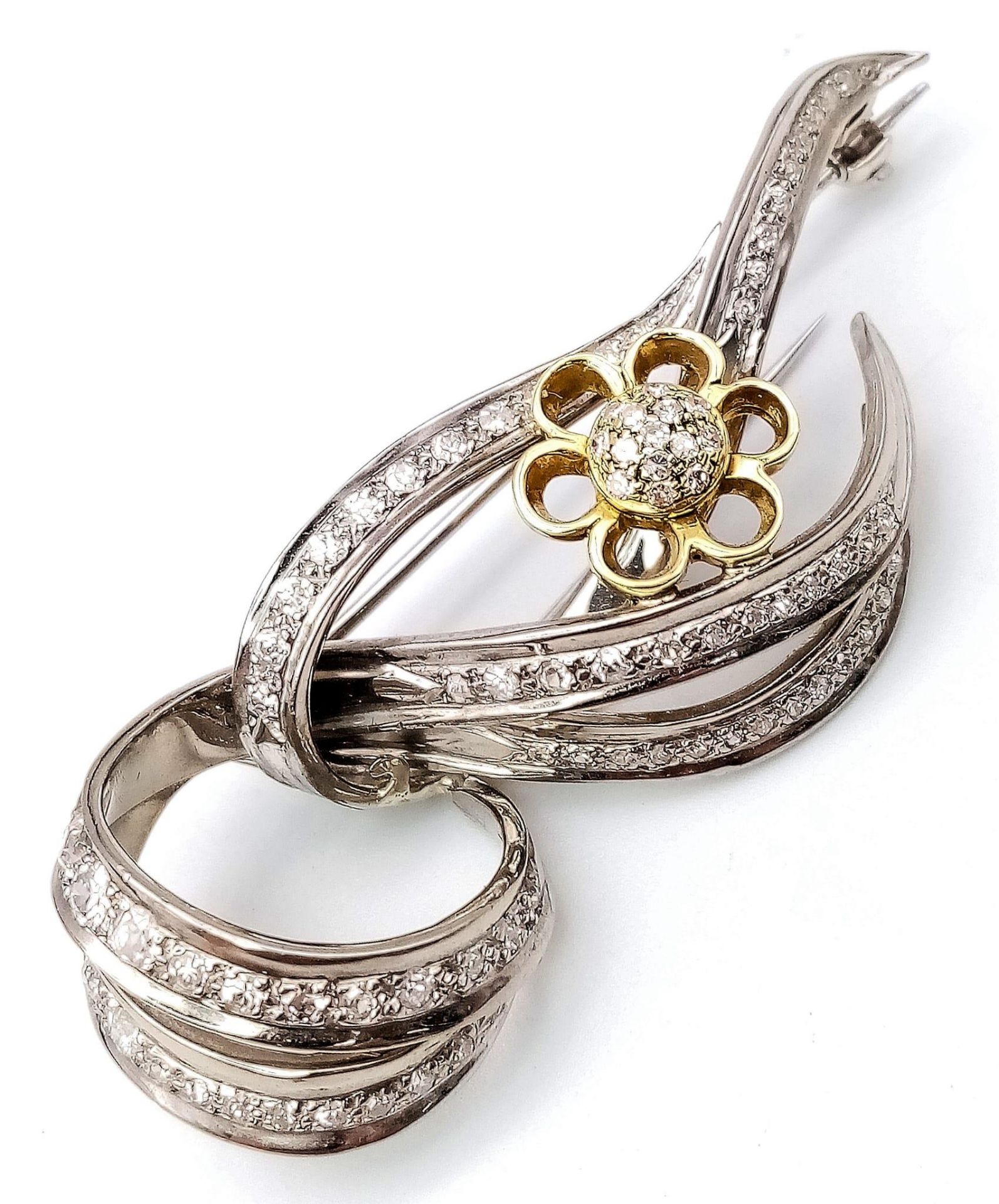 Diamond encrusted 18kt White & Yellow Gold Brooch. Beautifully woven White Gold design, adorned with