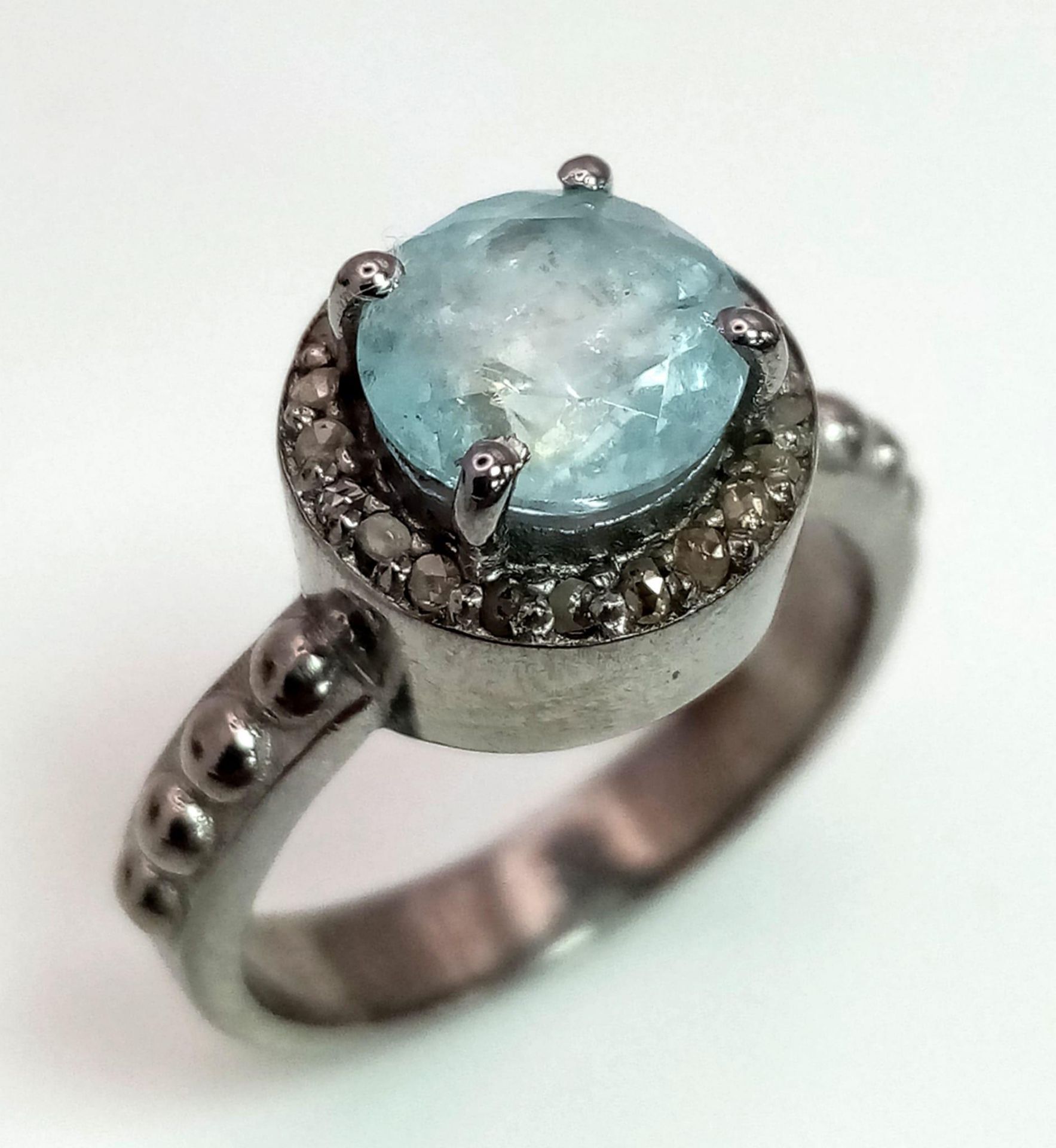 A Blue Topaz Ring with a Rose cut Diamond Halo. Set in 925 Sterling Silver. 1.50ct topaz. Diamond-