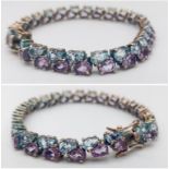 A Sterling Silver, double row bracelet set with Amethyst and Topaz. Measures 20cm in length. Weight: