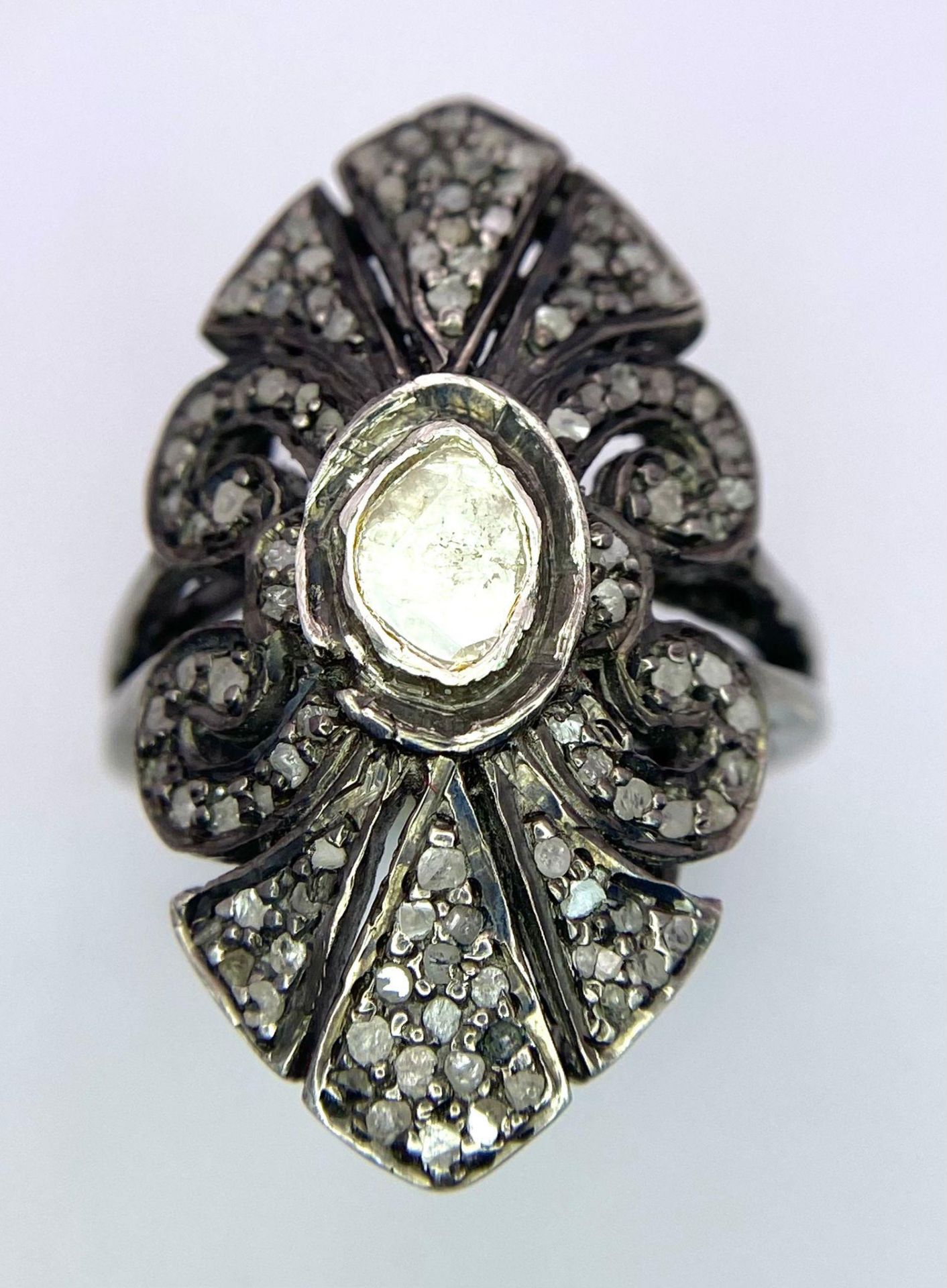 An Edwardian, ART NOUVEAU sterling silver ring with a large natural untreated diamond surrounded - Image 2 of 4