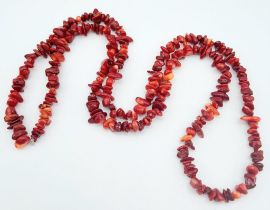 A long, Red Coral Beaded Necklace. Measures 80cm in length.