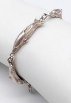 A Sterling Silver Dolphin bracelet. 6cm in diameter. Weight: 12.66g