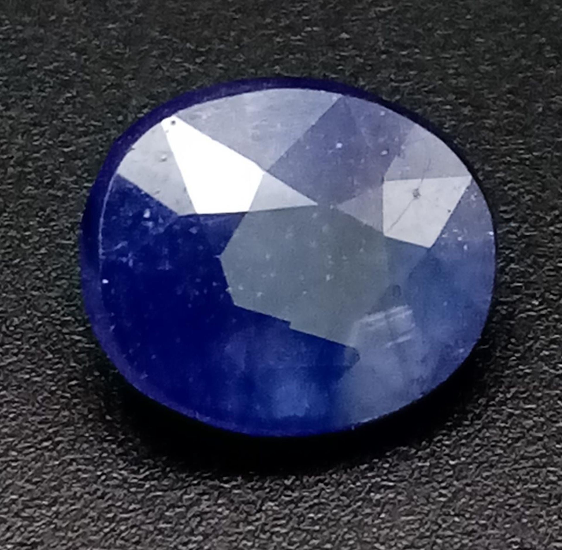A 4.96 Ct Faceted Natural African Blue Sapphire in Oval Shape. IGL&I Certified.