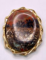 Fancy Agate Stone Brooch. Large stone framed by Gold Tone twisted metal border. Brooch measures