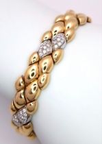 An 18K Yellow Gold and Diamond Ladies Bracelet. Rich gold droplets of 18k gold interspersed with