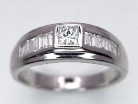 AN 18K WHITE GOLD DIAMOND BAND RING. 0.50ctw Princess and Baguette cut diamonds. Size M, 4.7g